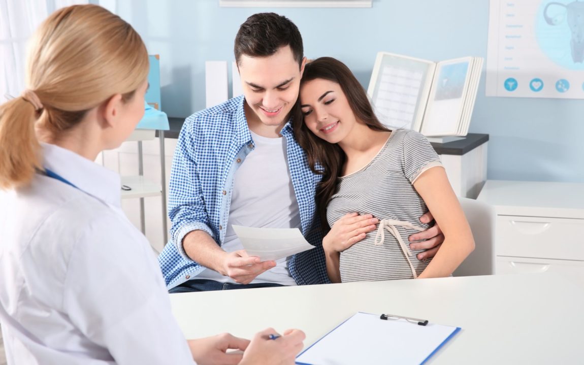 pregnant couple discussing weed with their family doctor