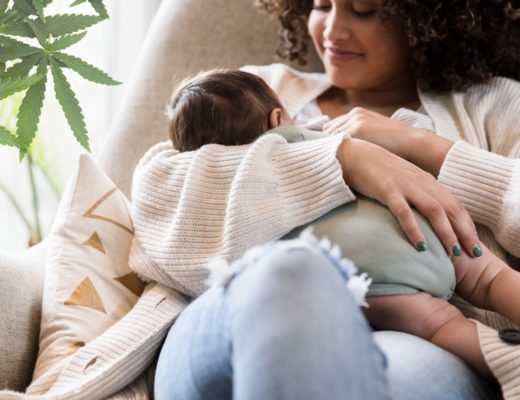new mother breastfeeding near a cannabis plant
